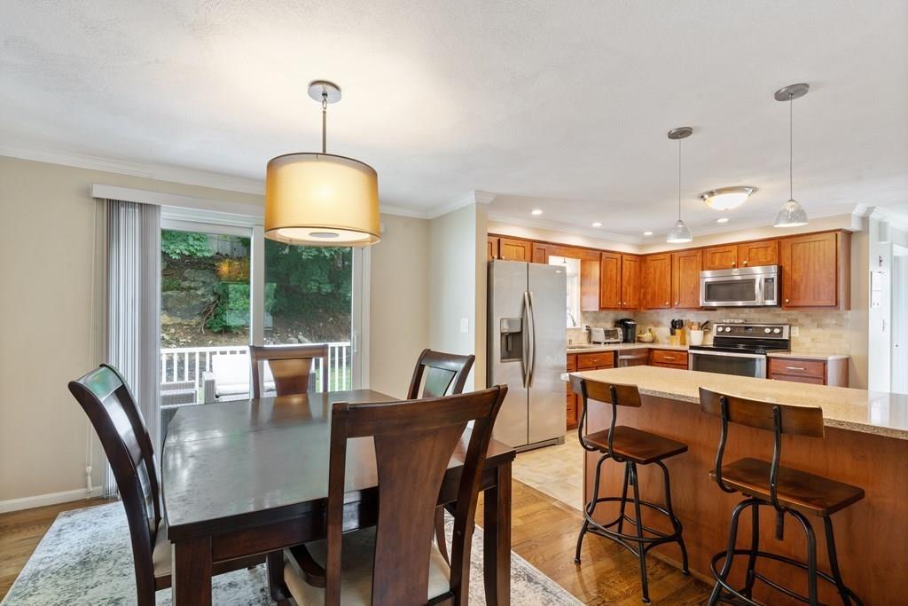 36 Intervale Road Waltham, MA 02453 - Photo 5 of 38 a dining room with furniture a chandelier and wooden floor