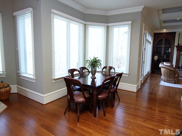 11200 Jonas Ridge Lane Raleigh, NC 27613 - Photo 12 of 25 a view of a dining room with furniture window and wooden floor