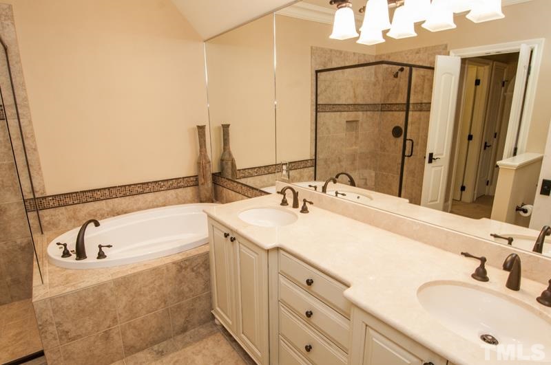11200 Jonas Ridge Lane Raleigh, NC 27613 - Photo 16 of 25 a bathroom with a tub sink and mirror