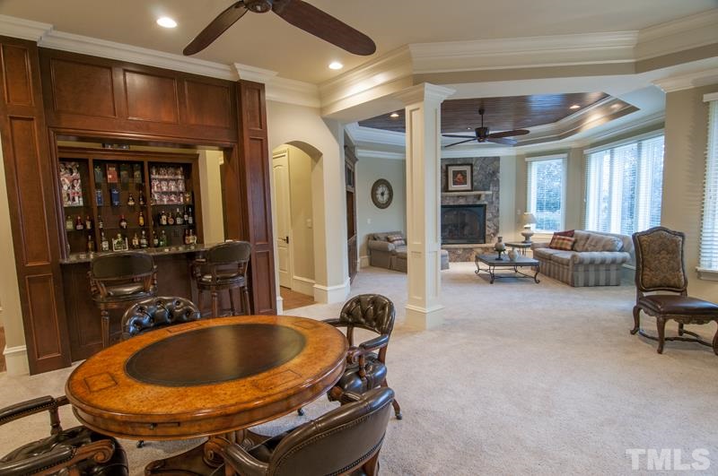11200 Jonas Ridge Lane Raleigh, NC 27613 - Photo 18 of 25 a living room with furniture a fireplace and gym equipment