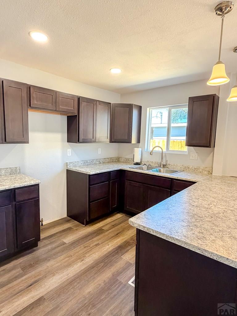 809 West 4th Street La Junta, CO 81050 - Photo 11 of 15 a kitchen with stainless steel appliances granite countertop a sink counter space and cabinets