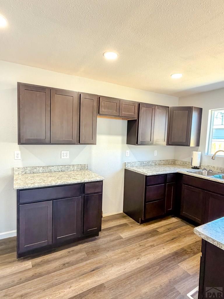 809 West 4th Street La Junta, CO 81050 - Photo 12 of 15 a kitchen with stainless steel appliances granite countertop a sink and cabinets