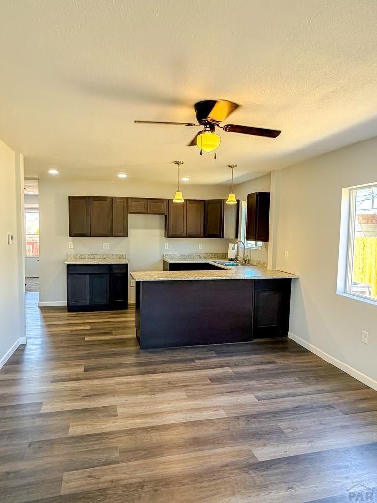 809 West 4th Street La Junta, CO 81050 - Photo 13 of 15 a living room with stainless steel appliances kitchen island a stove and a sink