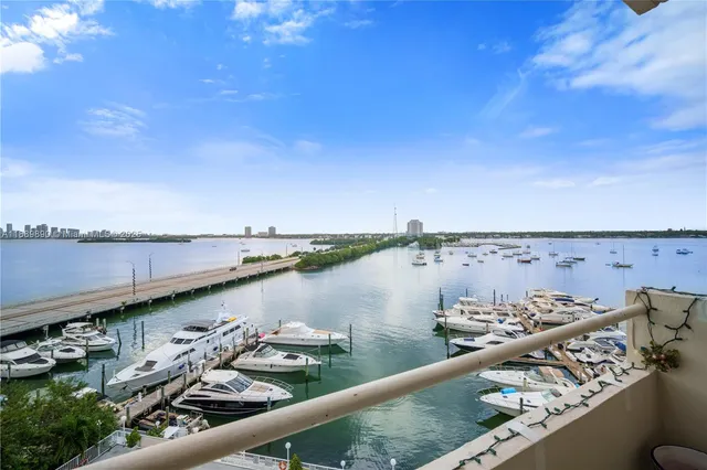 a bedroom with furniture and a large window