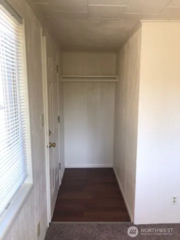 a view of a room with a door and a window