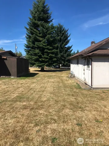 a view of a backyard of the house