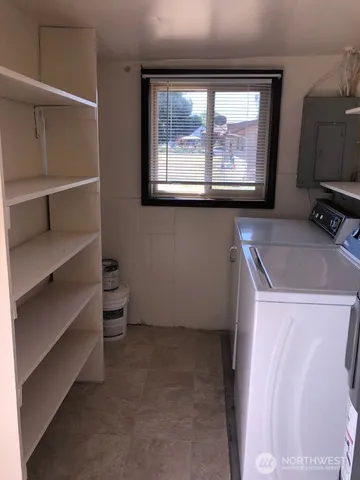 a view of storage and utility room with a window