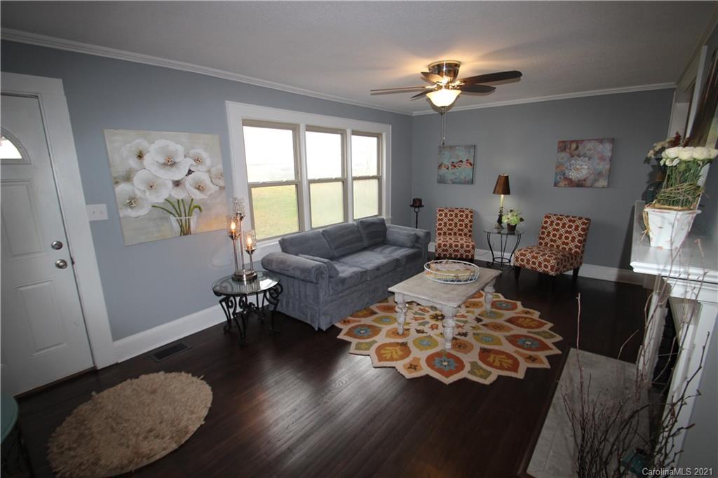 4645 Poplar Tent Road Concord, NC 28027 - Photo 4 of 25 a living room with furniture and a chandelier