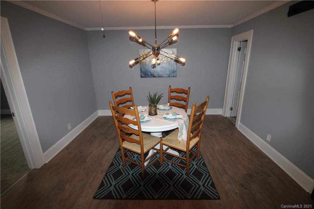 4645 Poplar Tent Road Concord, NC 28027 - Photo 9 of 25 a view of a dining room with furniture and wooden floor