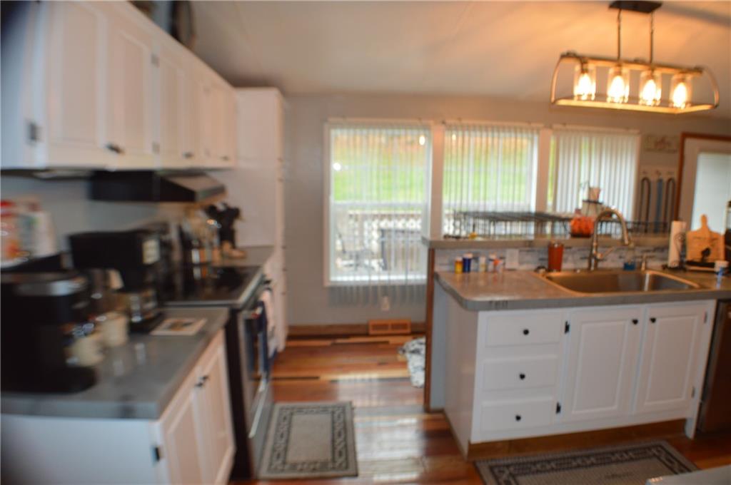 188 Cope Road Perryopolis, PA 15473 - Photo 4 of 21 a kitchen with a sink stove and cabinets