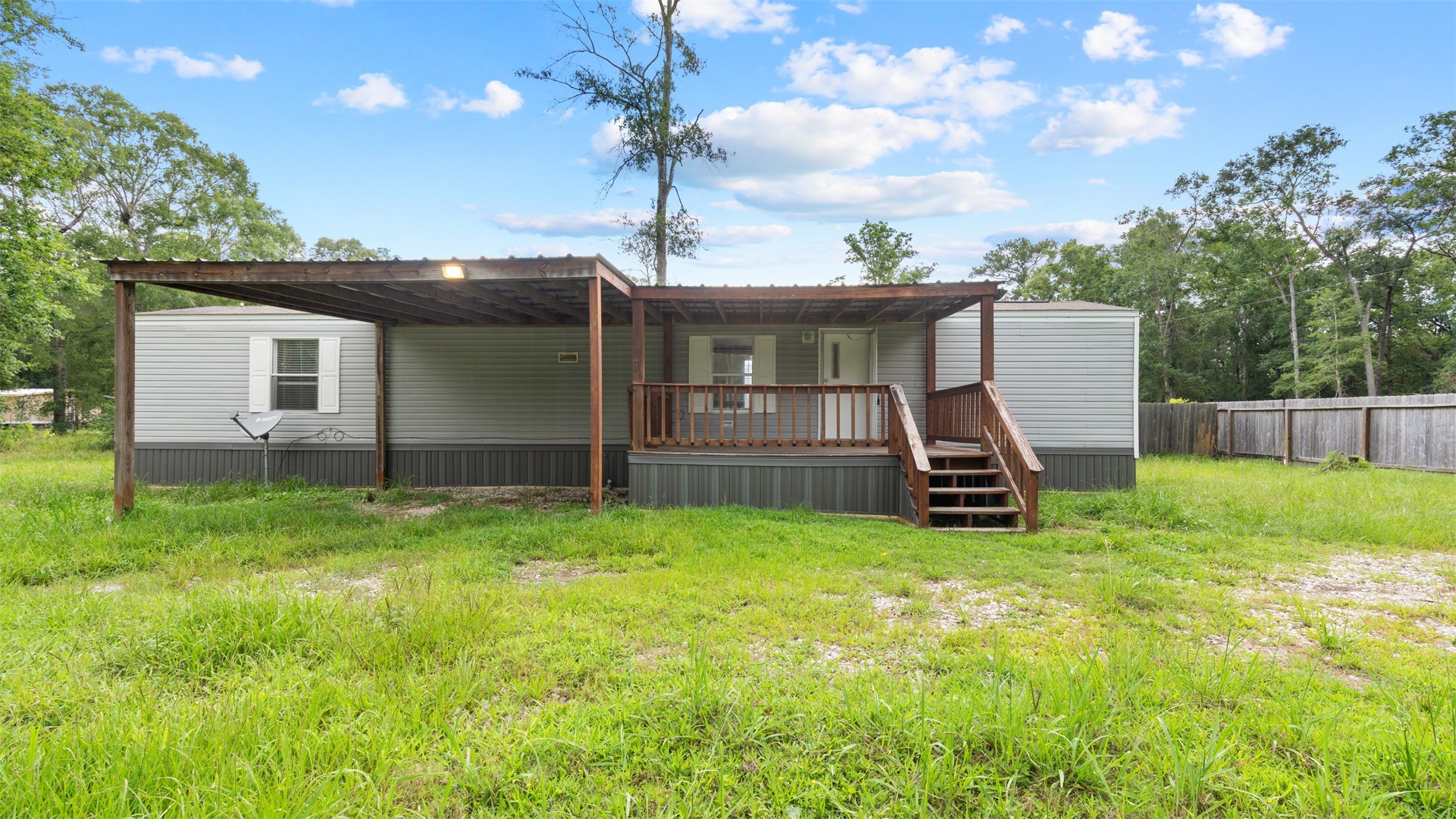 91 Maple Lane Shepherd, TX 77371 - Photo 1 of 15 a view of backyard with a garden and deck