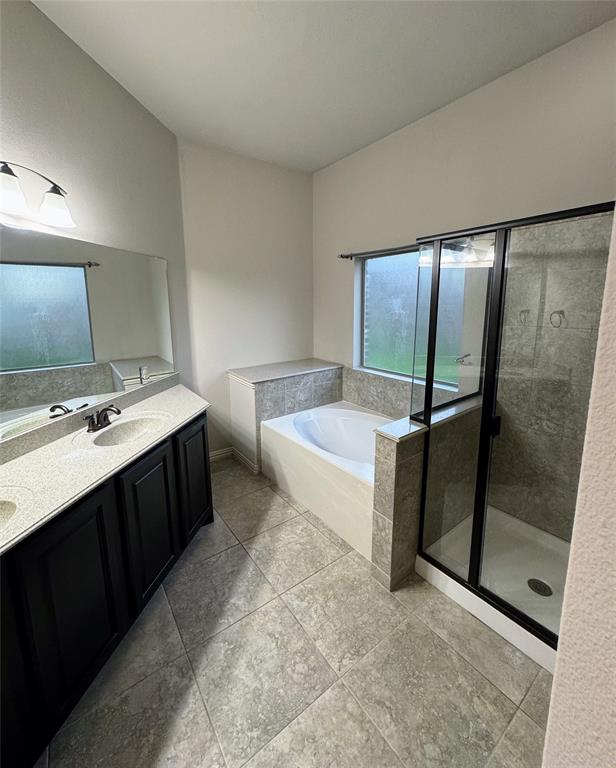 236 Archer Way Forney, TX 75126 - Photo 31 of 35 a spacious bathroom with a double vanity sink mirror and bathtub