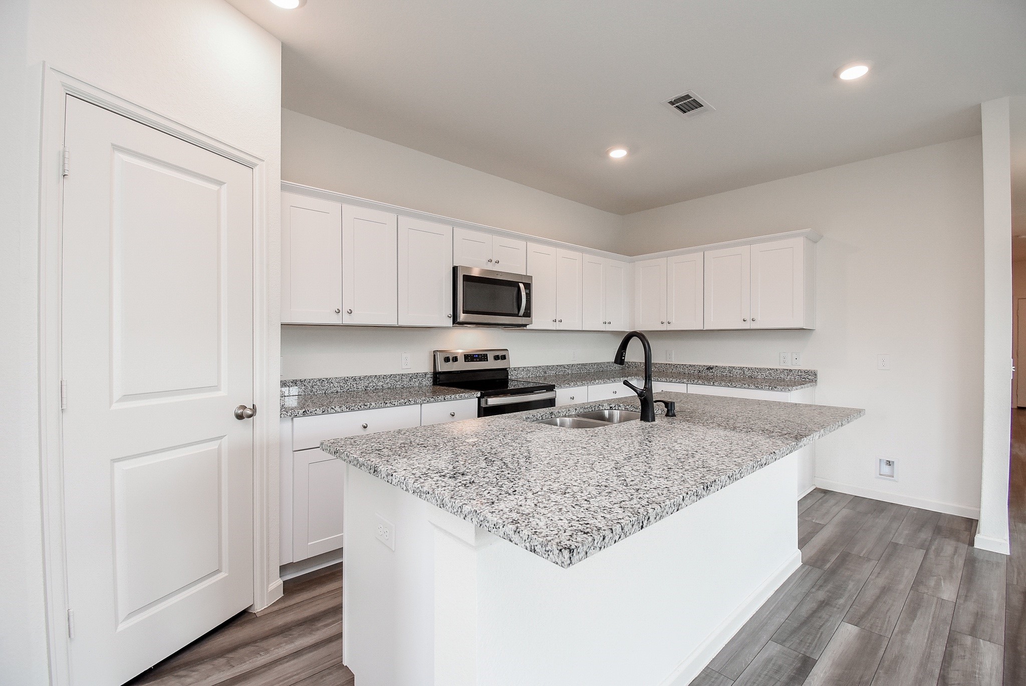 13542 Kinsman Road Houston, TX 77049 - Photo 12 of 43 a kitchen with granite countertop a sink and a stove top oven