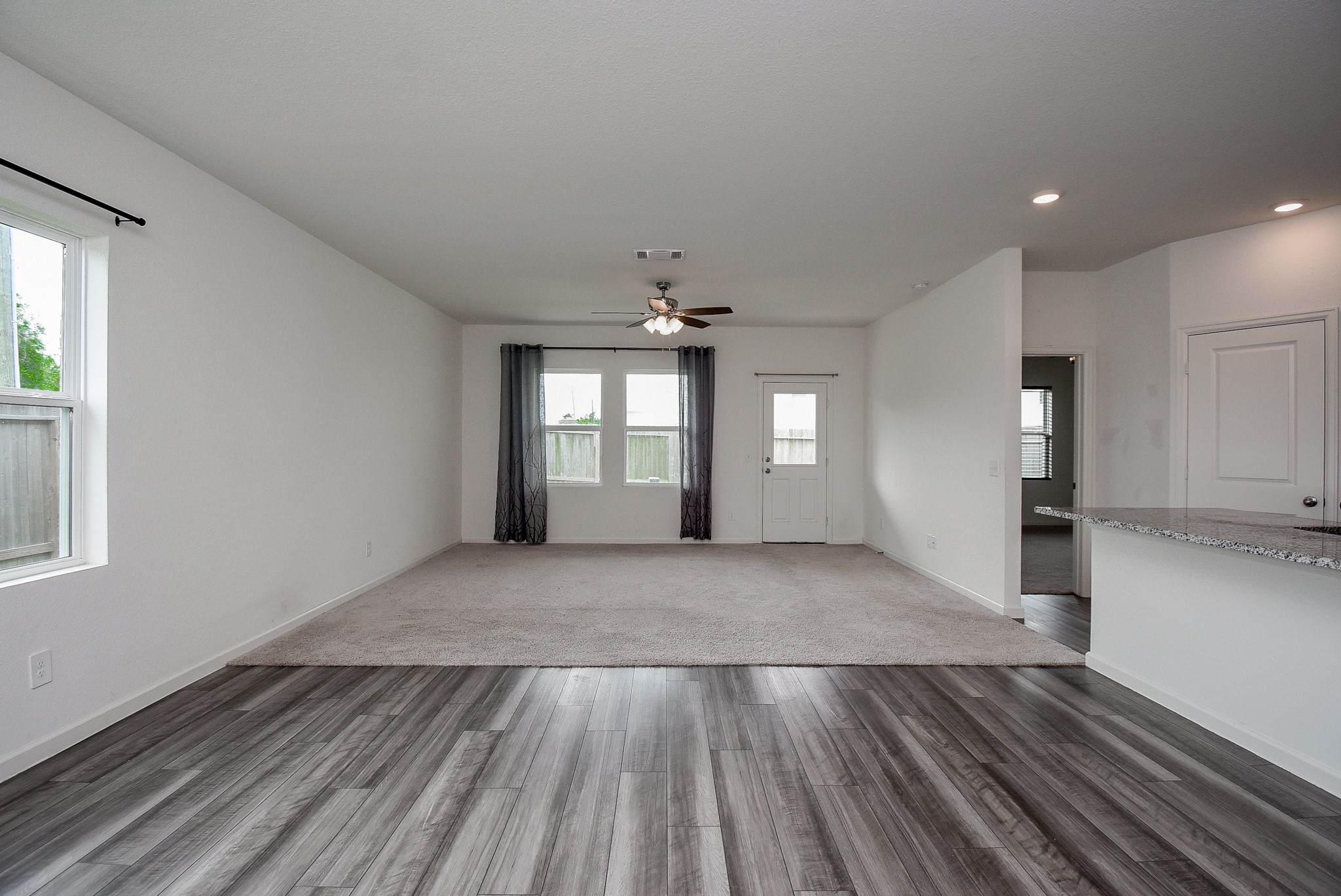 13542 Kinsman Road Houston, TX 77049 - Photo 13 of 43 wooden floor in an empty room with a window