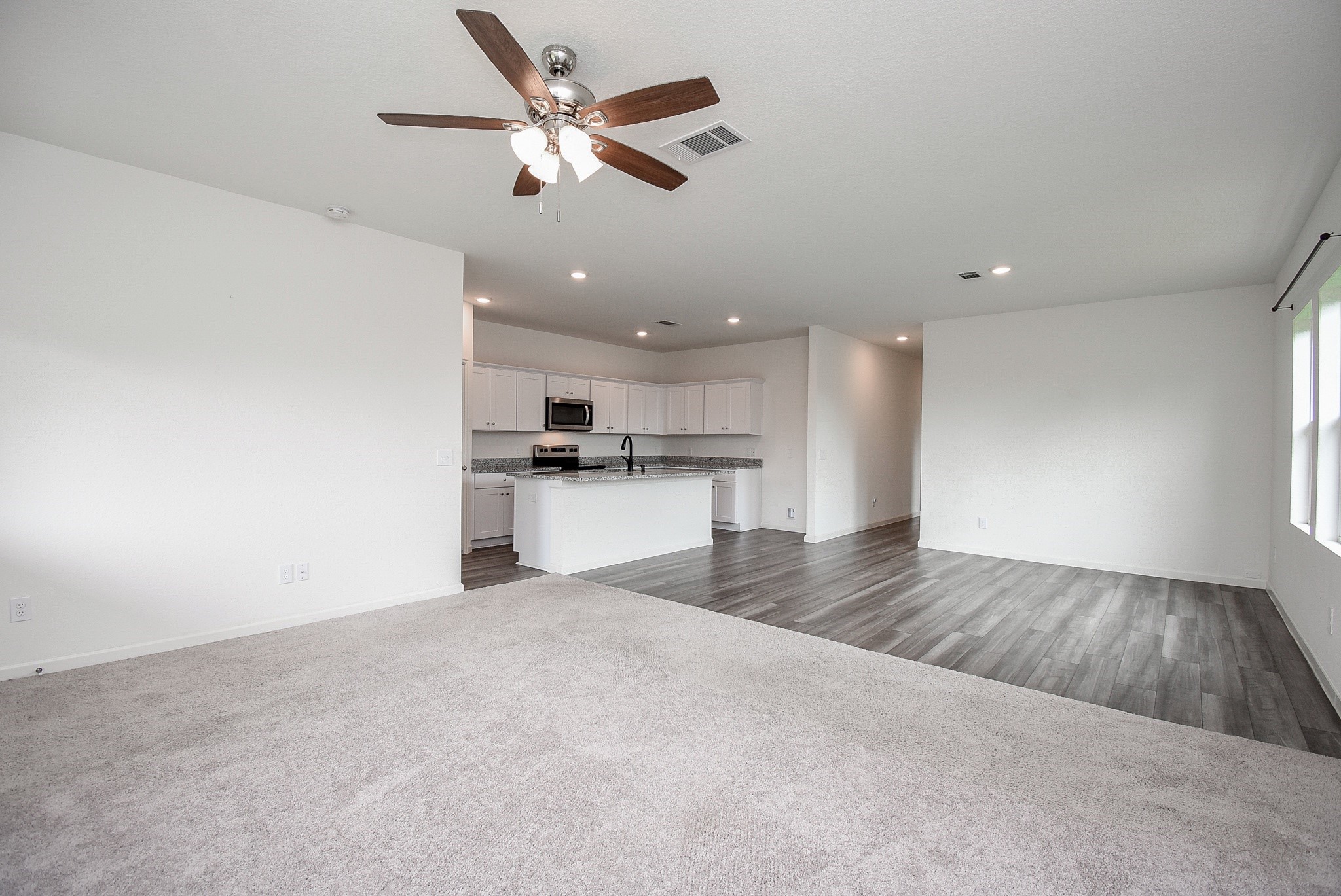 13542 Kinsman Road Houston, TX 77049 - Photo 16 of 43 a view of kitchen with refrigerator and wooden floor