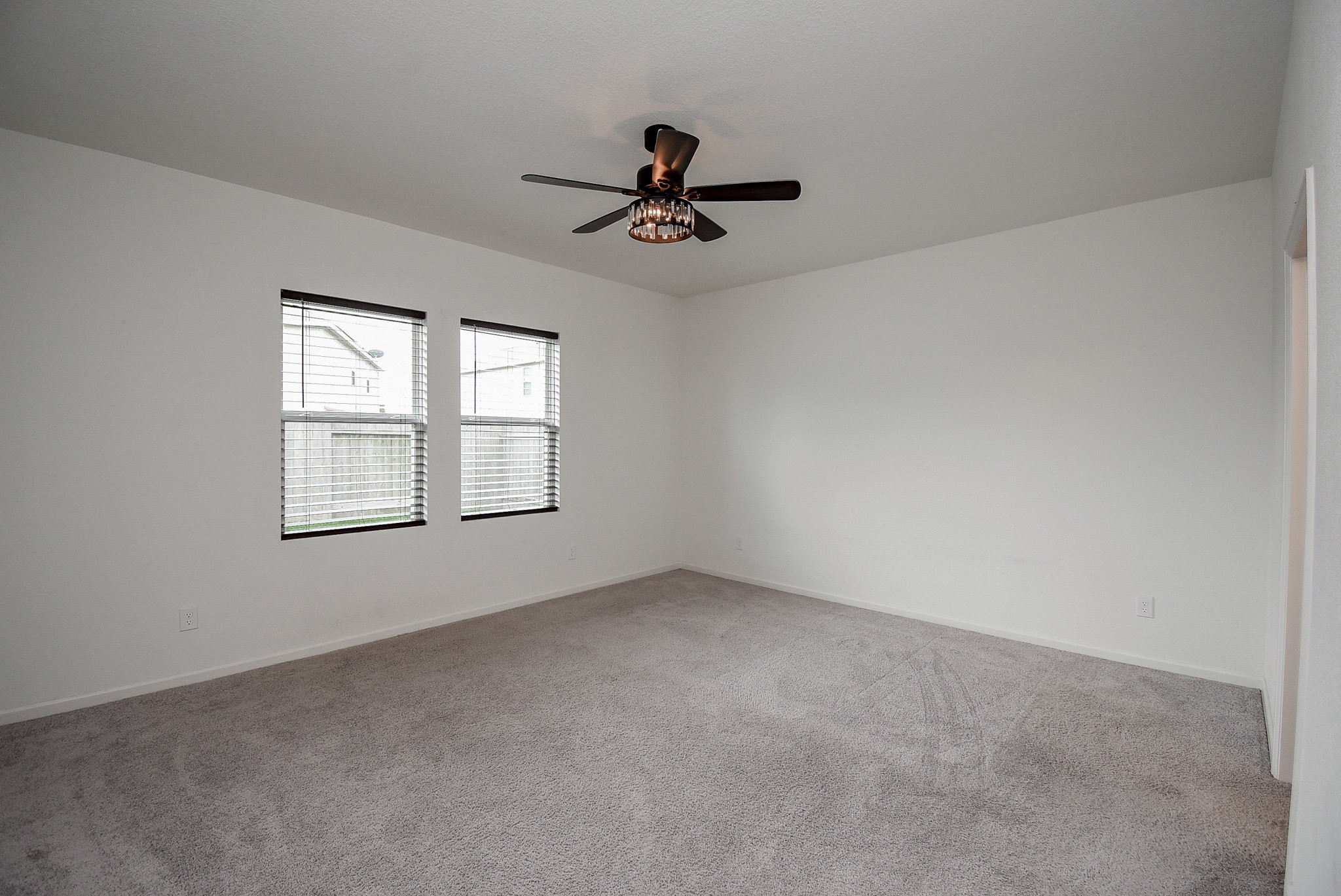 13542 Kinsman Road Houston, TX 77049 - Photo 17 of 43 an empty room with windows and fan