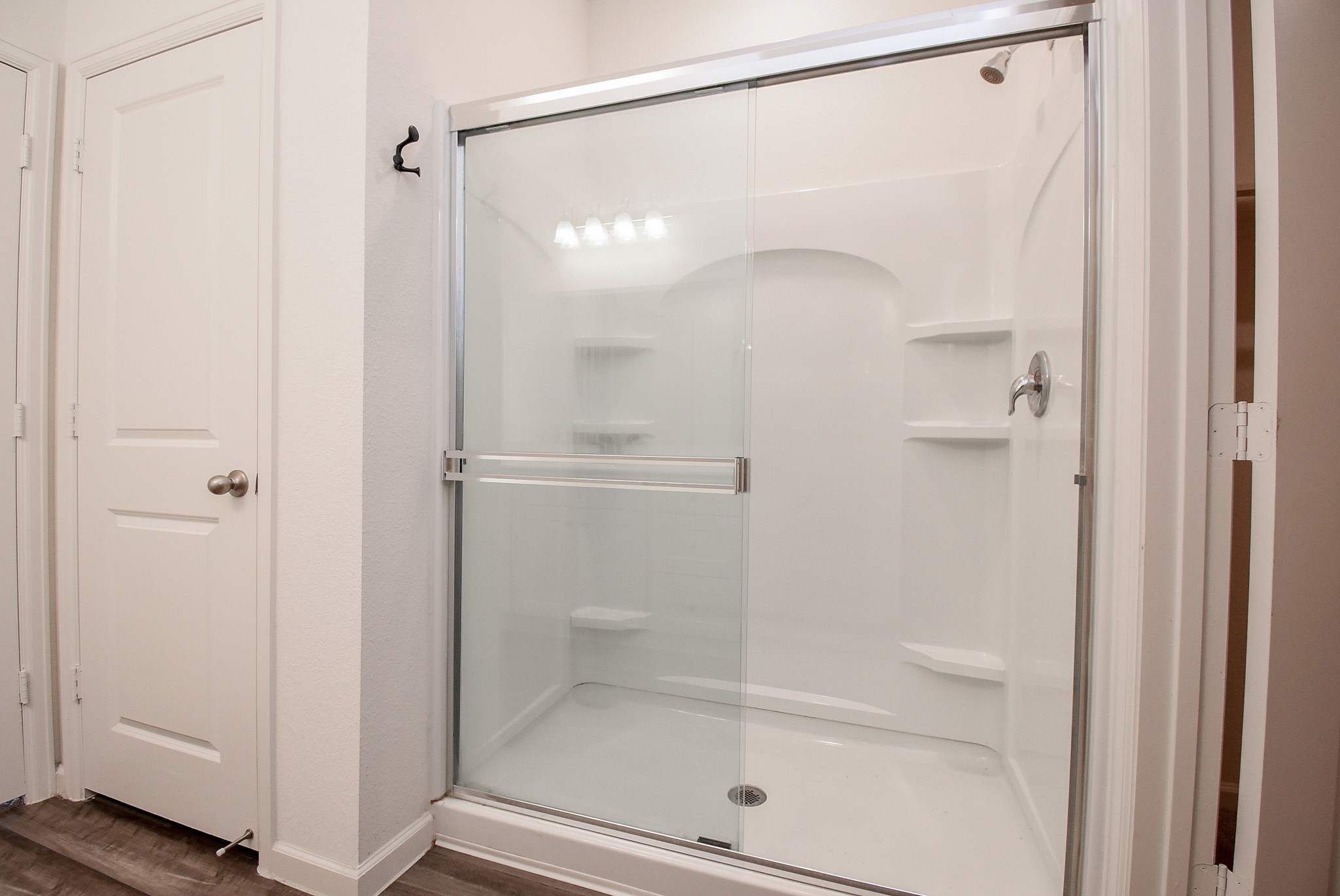 13542 Kinsman Road Houston, TX 77049 - Photo 21 of 43 a bathroom with a glass shower door