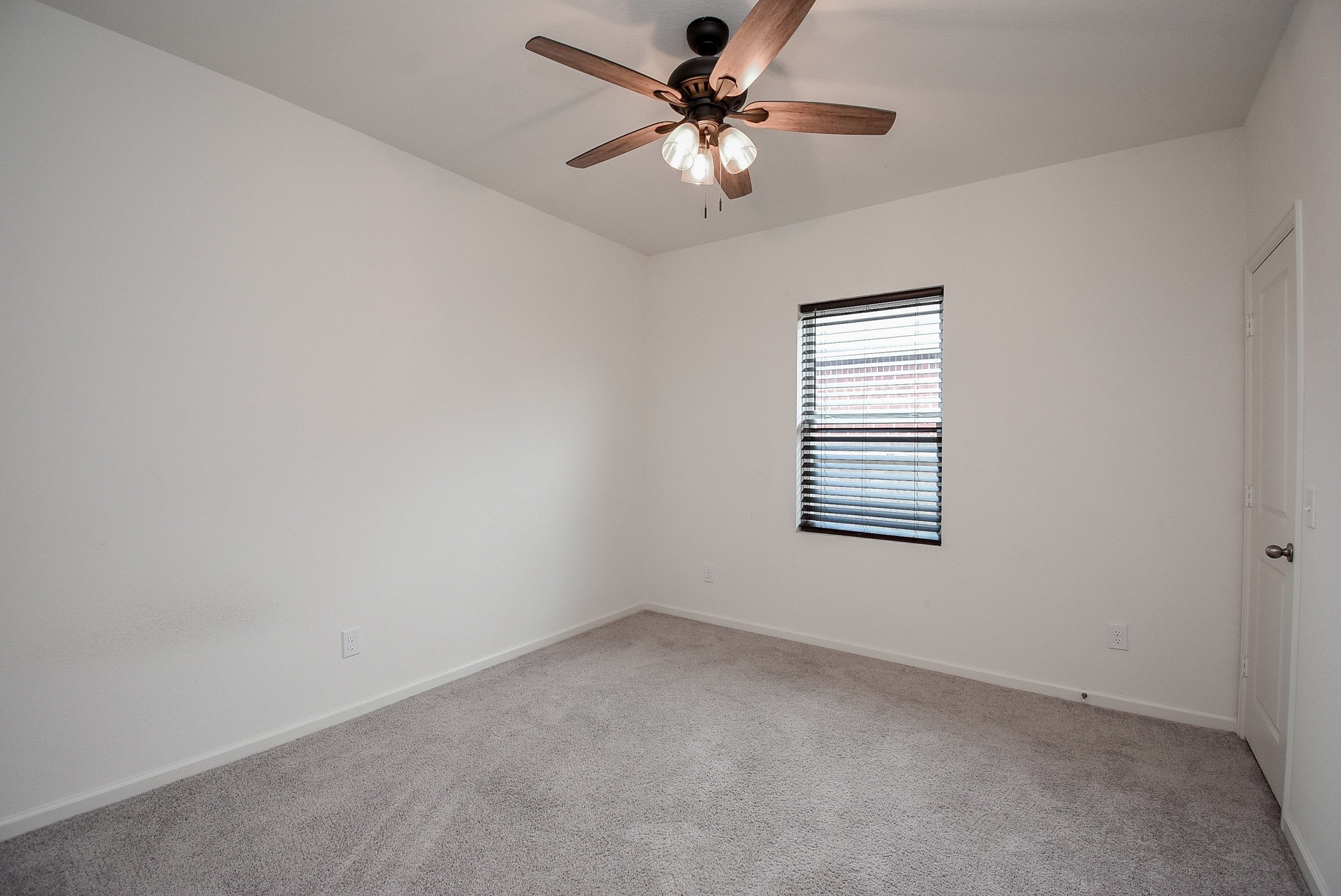 13542 Kinsman Road Houston, TX 77049 - Photo 23 of 43 an empty room with a window and a fan