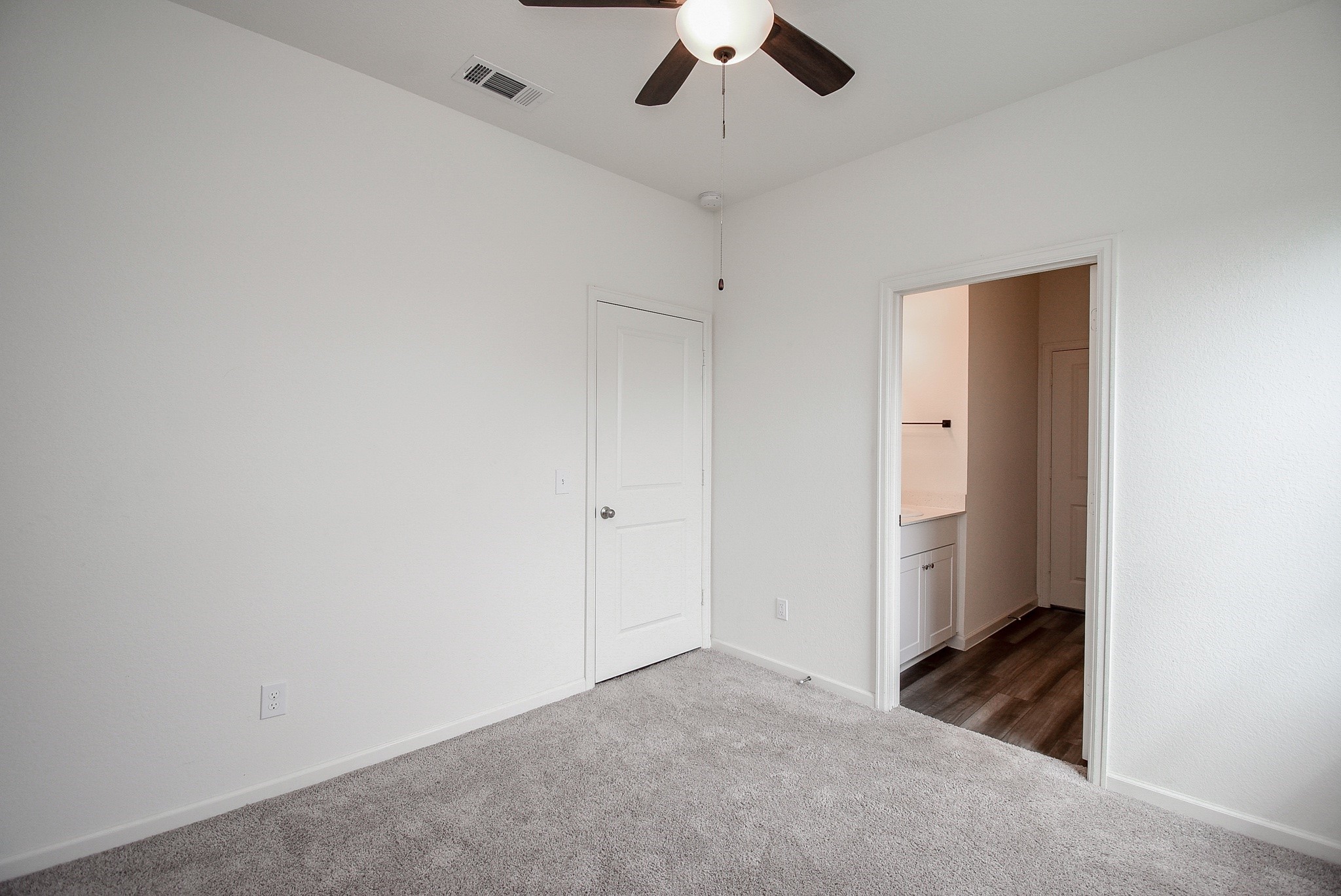 13542 Kinsman Road Houston, TX 77049 - Photo 24 of 43 an empty room with a ceiling fan and carpet