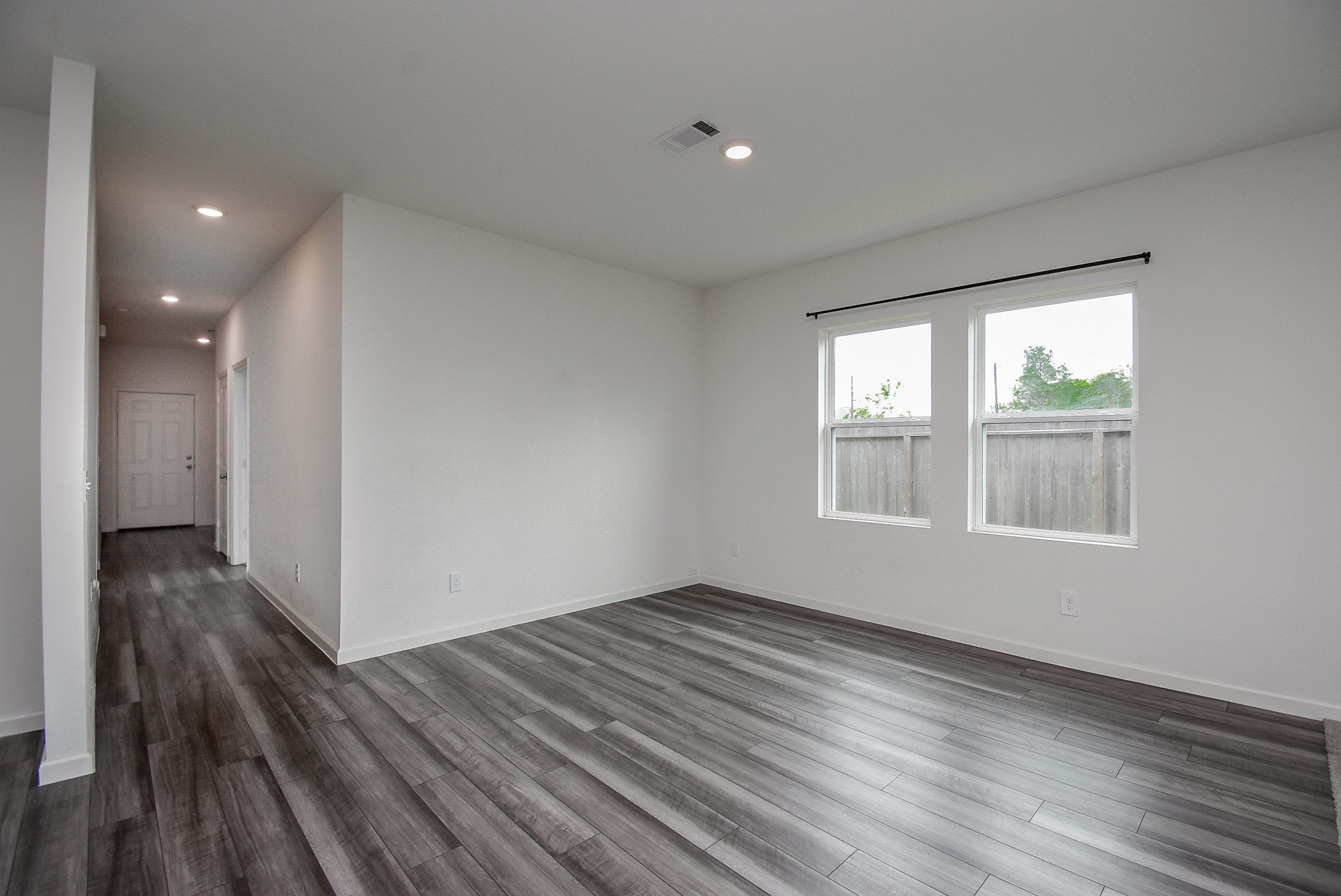 13542 Kinsman Road Houston, TX 77049 - Photo 6 of 43 a view of empty room with wooden floor and fan