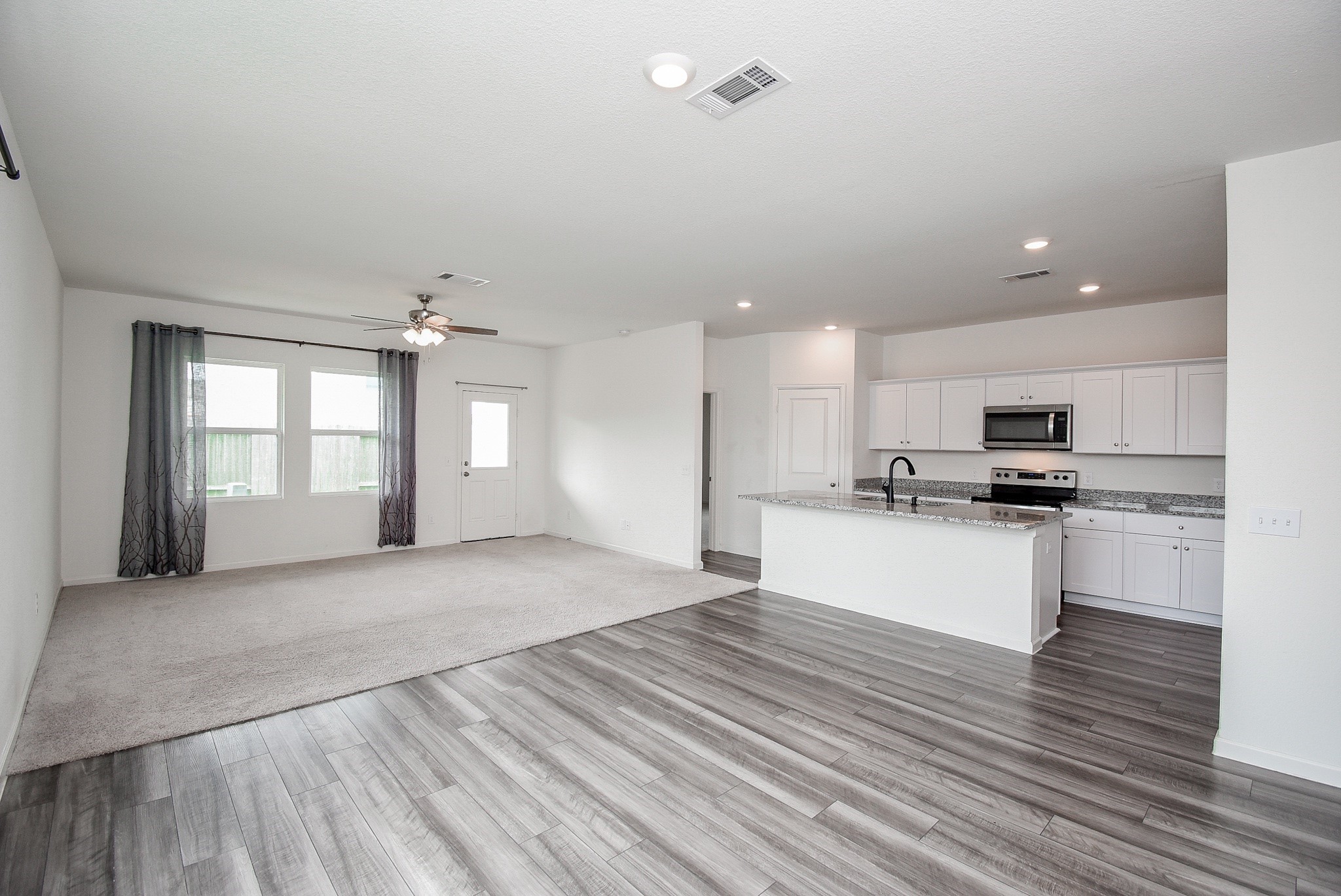 13542 Kinsman Road Houston, TX 77049 - Photo 7 of 43 a view of kitchen with kitchen island stainless steel appliances refrigerator stove microwave and cabinets