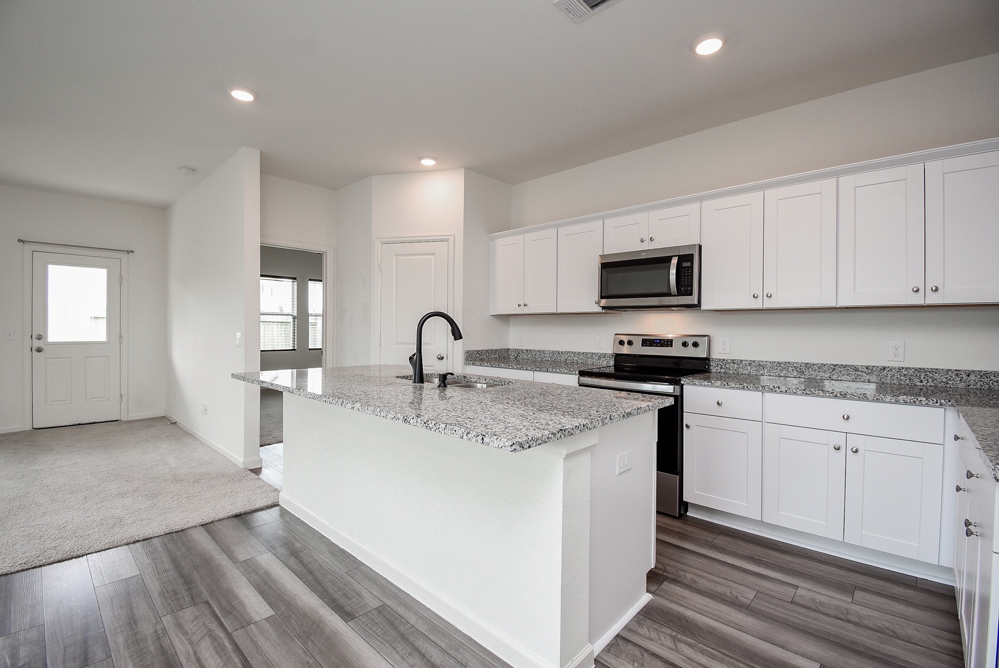 13542 Kinsman Road Houston, TX 77049 - Photo 8 of 43 a kitchen with stainless steel appliances granite countertop a sink stove microwave and cabinets