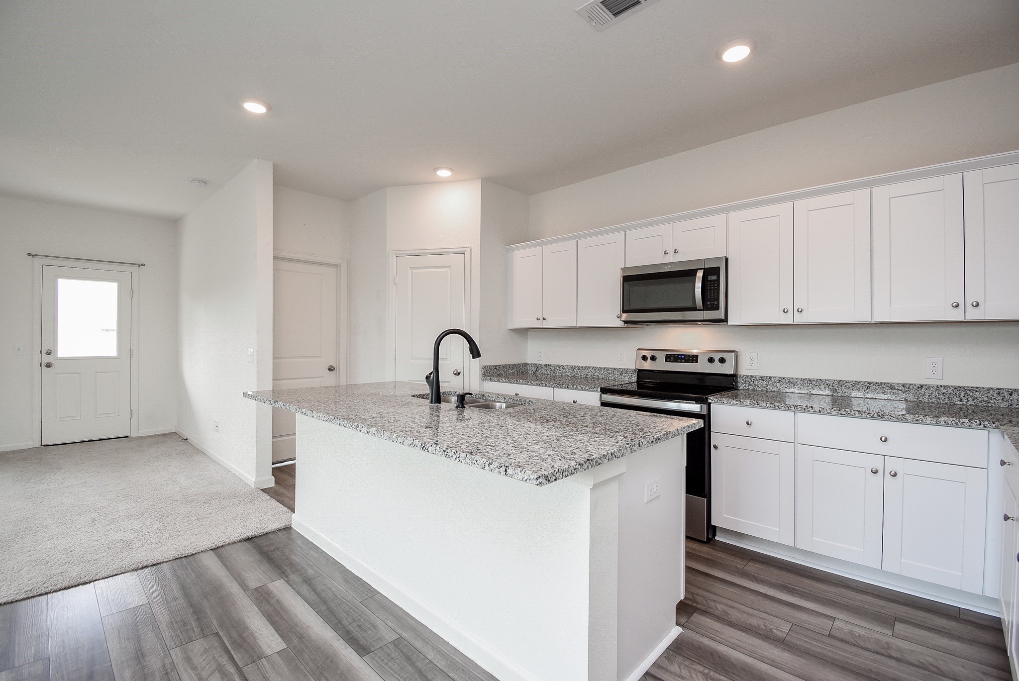 13542 Kinsman Road Houston, TX 77049 - Photo 10 of 43 a kitchen with sink a microwave and cabinets