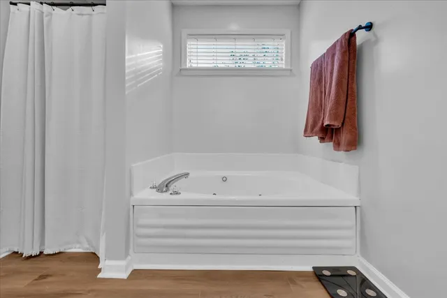 a living room with a baby crib furniture and a chandelier