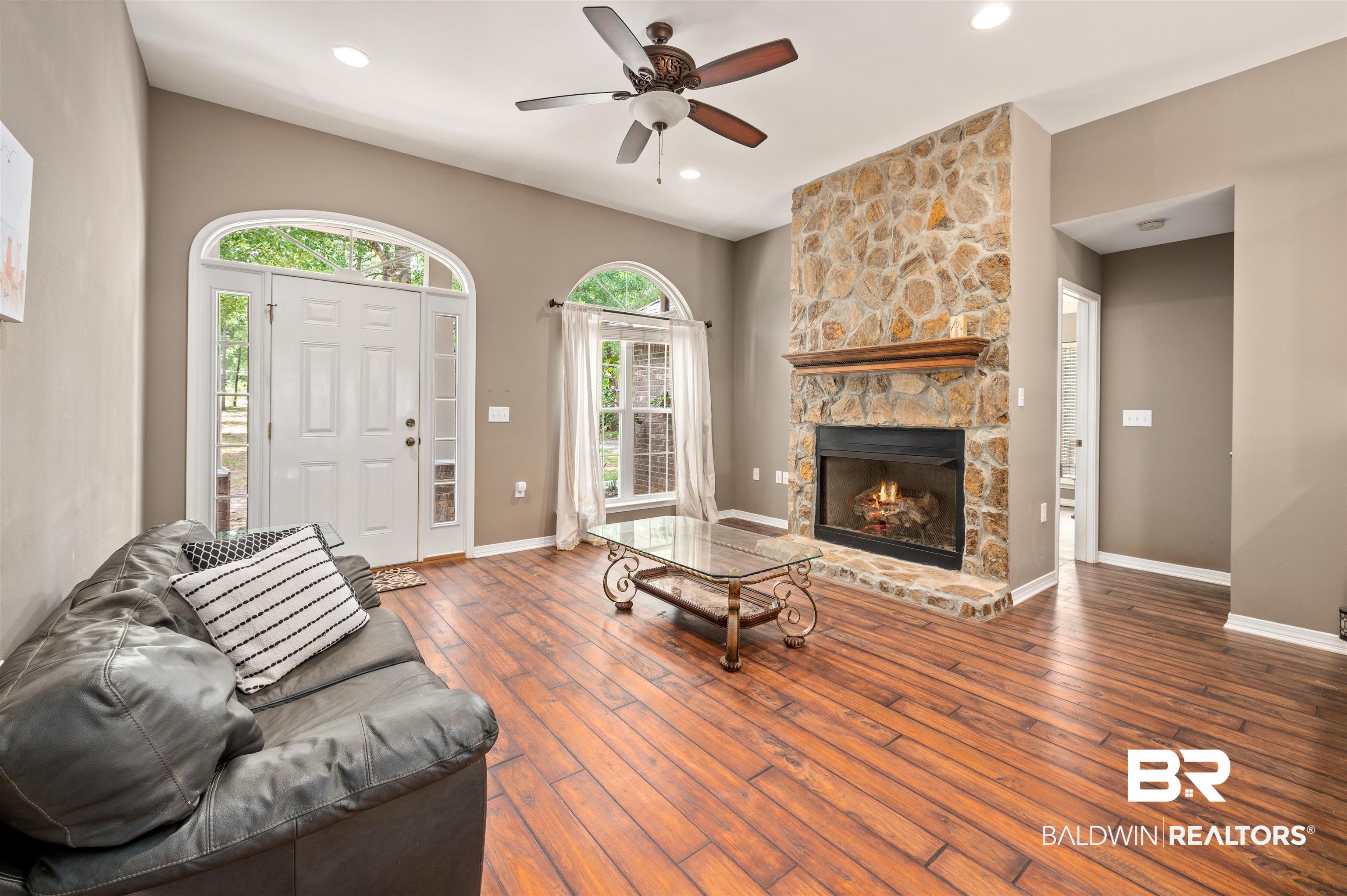 15240 Styx River Road Stapleton, AL 36578 - Photo 17 of 18 Living room with a fireplace, dark hardwood / wood-style flooring, and ceiling fan