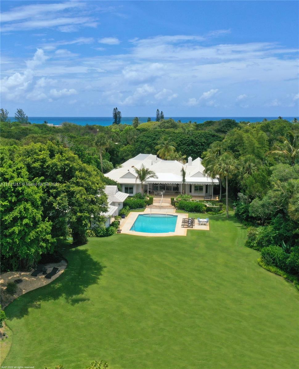 318 South Beach Road Hobe Sound, FL 33455 - Photo 11 of 69 a view of a big yard with a house in the background