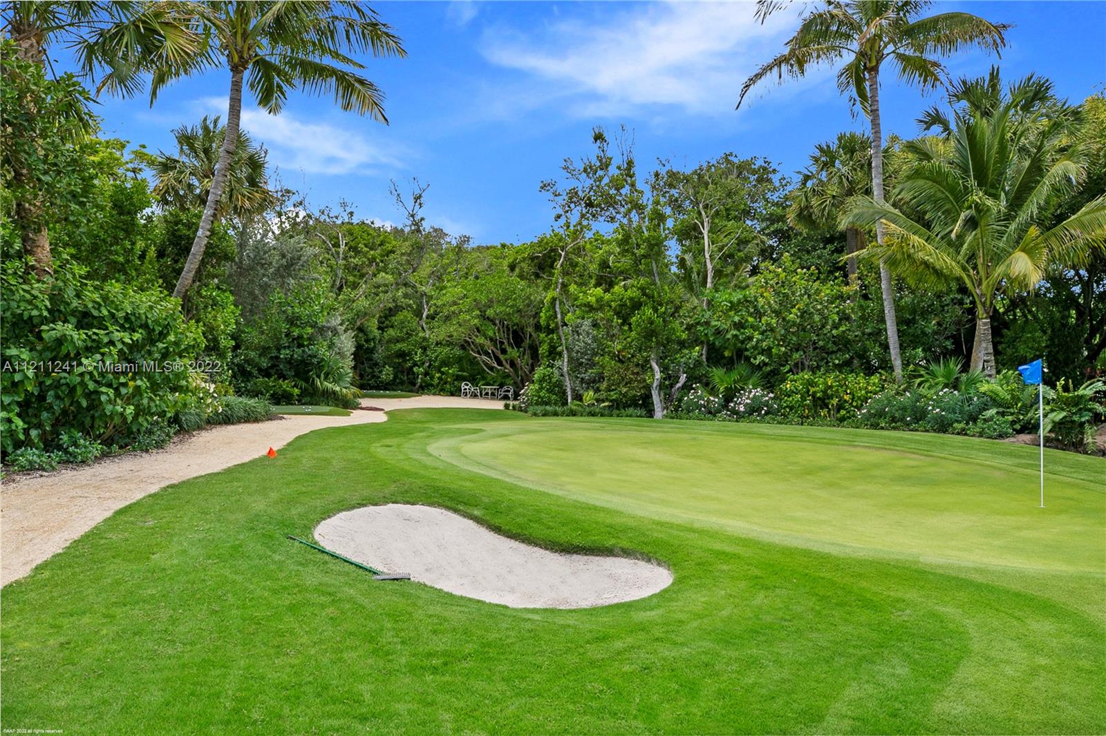 318 South Beach Road Hobe Sound, FL 33455 - Photo 18 of 69 a view of a golf course with a garden