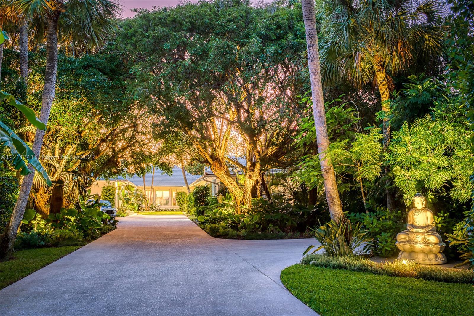 318 South Beach Road Hobe Sound, FL 33455 - Photo 28 of 69 a view of a yard with plants and trees