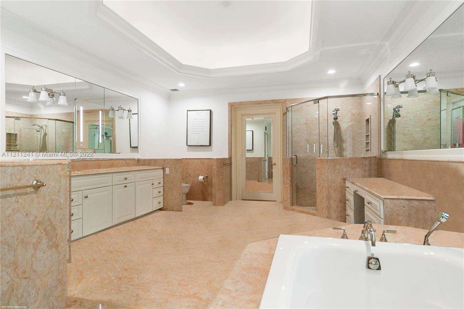 318 South Beach Road Hobe Sound, FL 33455 - Photo 42 of 69 a spacious bathroom with a double vanity sink mirror and shower