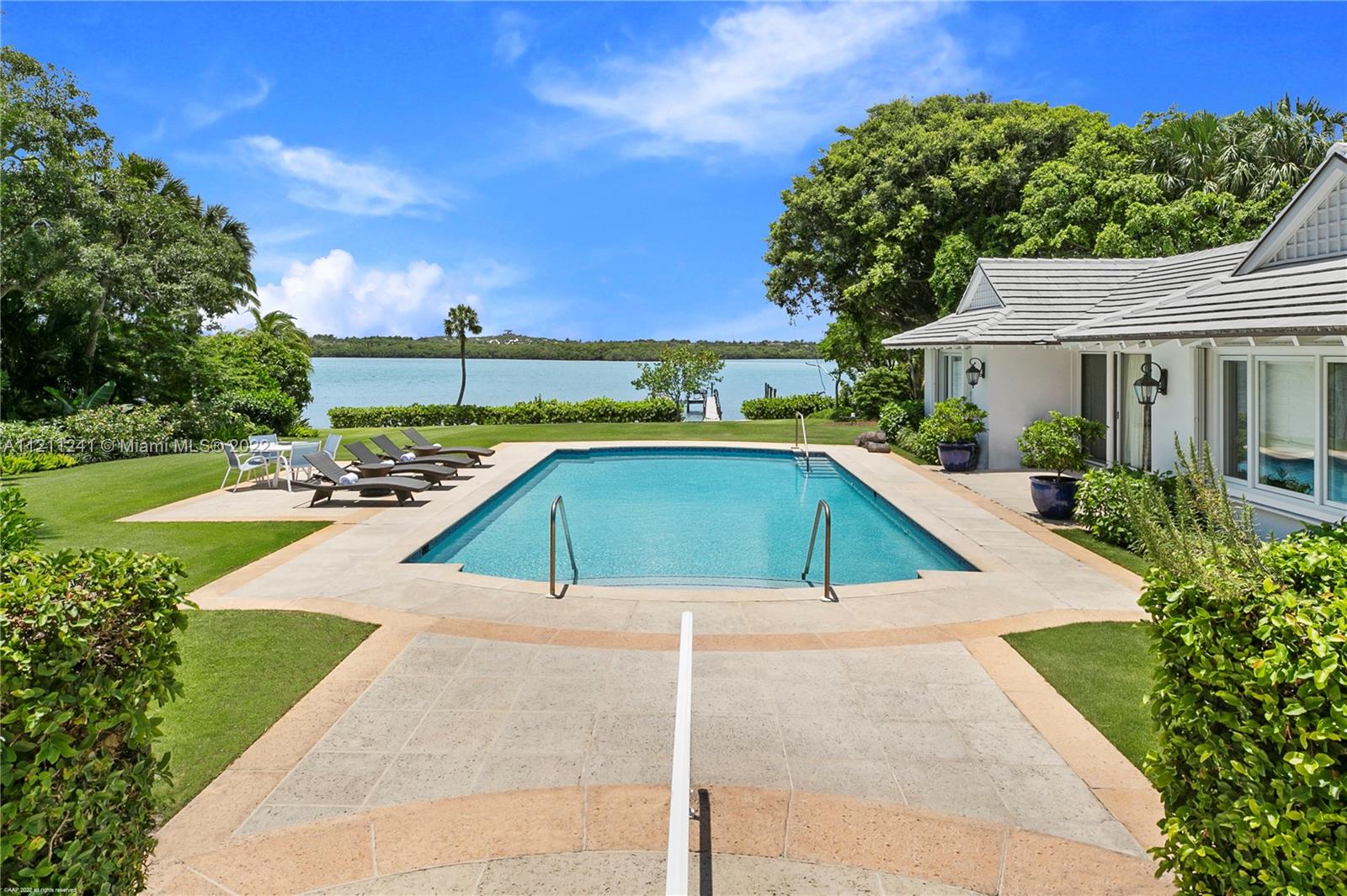318 South Beach Road Hobe Sound, FL 33455 - Photo 46 of 69 a view of a swimming pool with a lounge chairs