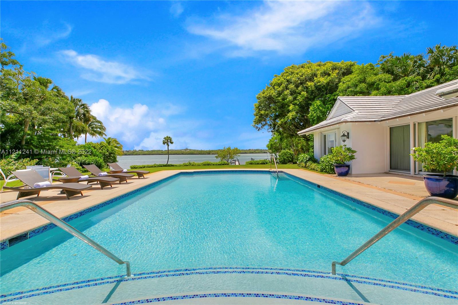 318 South Beach Road Hobe Sound, FL 33455 - Photo 47 of 69 a view of a backyard with swimming pool and outdoor seating