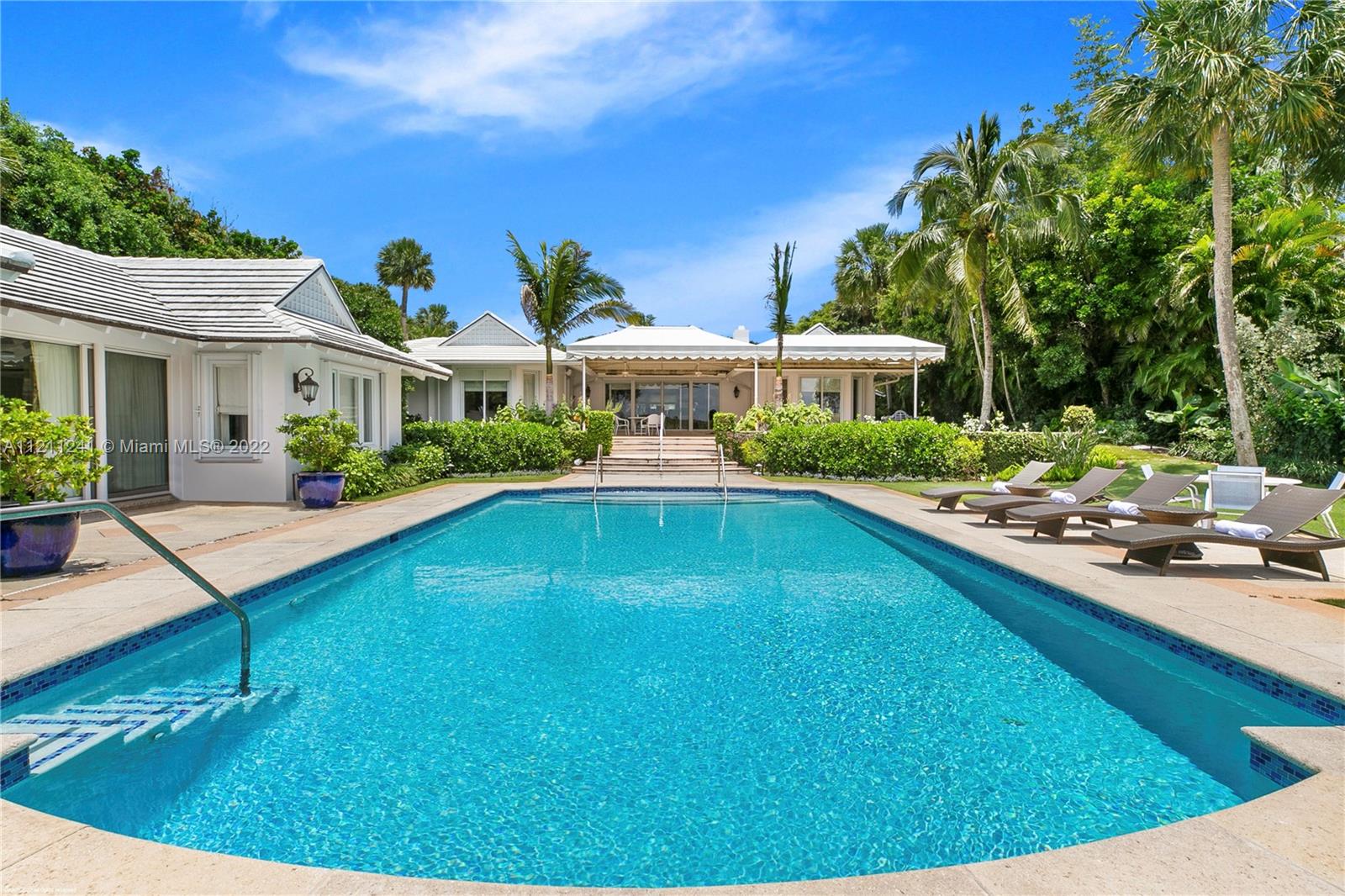 318 South Beach Road Hobe Sound, FL 33455 - Photo 50 of 69 a view of a house with pool fire pit and chairs
