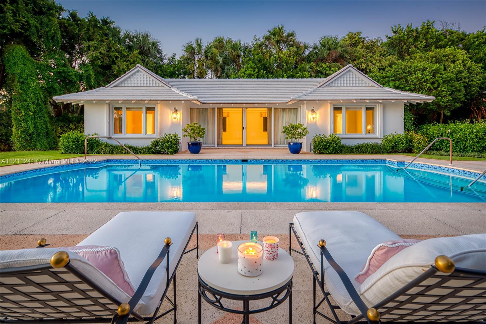 318 South Beach Road Hobe Sound, FL 33455 - Photo 53 of 69 a front view of a house with swimming pool having outdoor seating