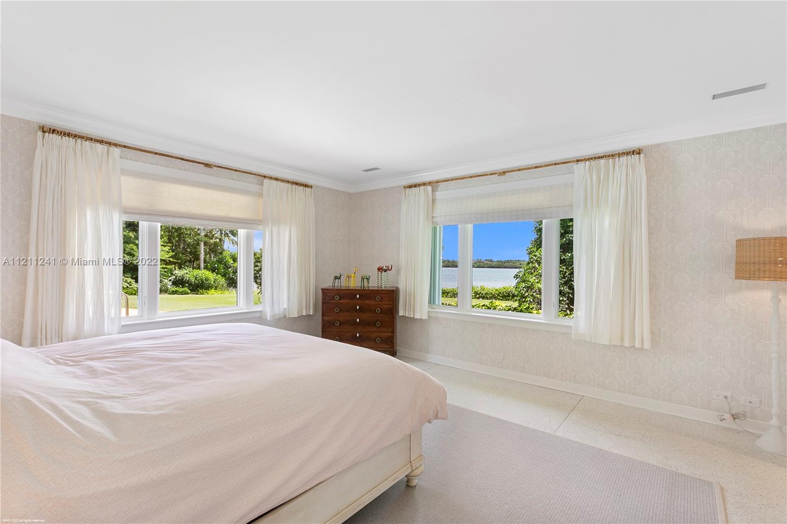 318 South Beach Road Hobe Sound, FL 33455 - Photo 56 of 69 a bed sitting in a spacious bedroom next to a window