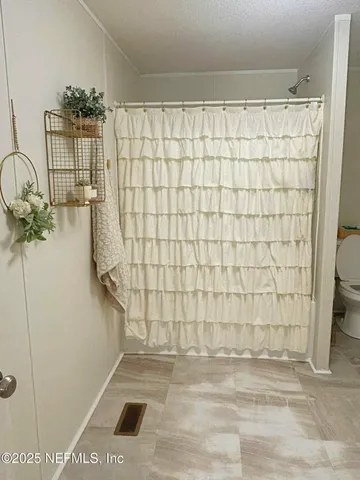 a view of a big yard with a large trees