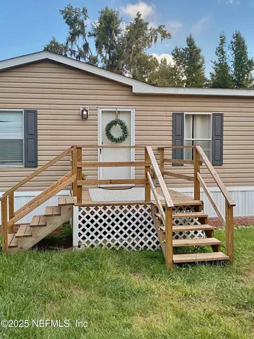 a view of a porch with furniture and a potted plant