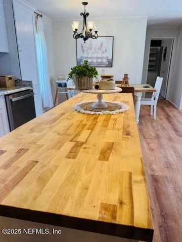 a bedroom with a bed and painting on the wall