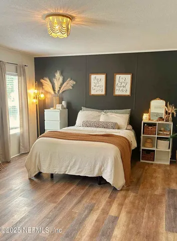 a bedroom with furniture and window