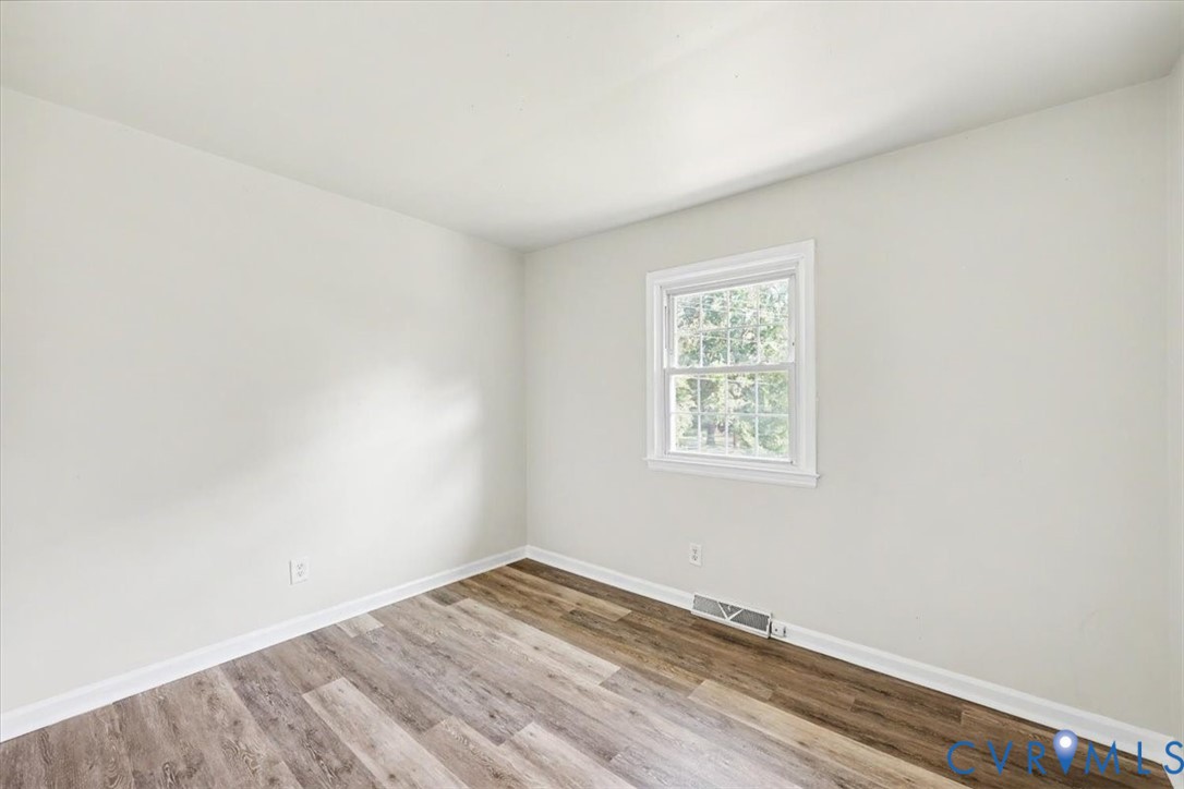 9737 Graves Road Petersburg, VA 23803 - Photo 16 of 41 Wood-finish flooring, white walls, and a window wi
