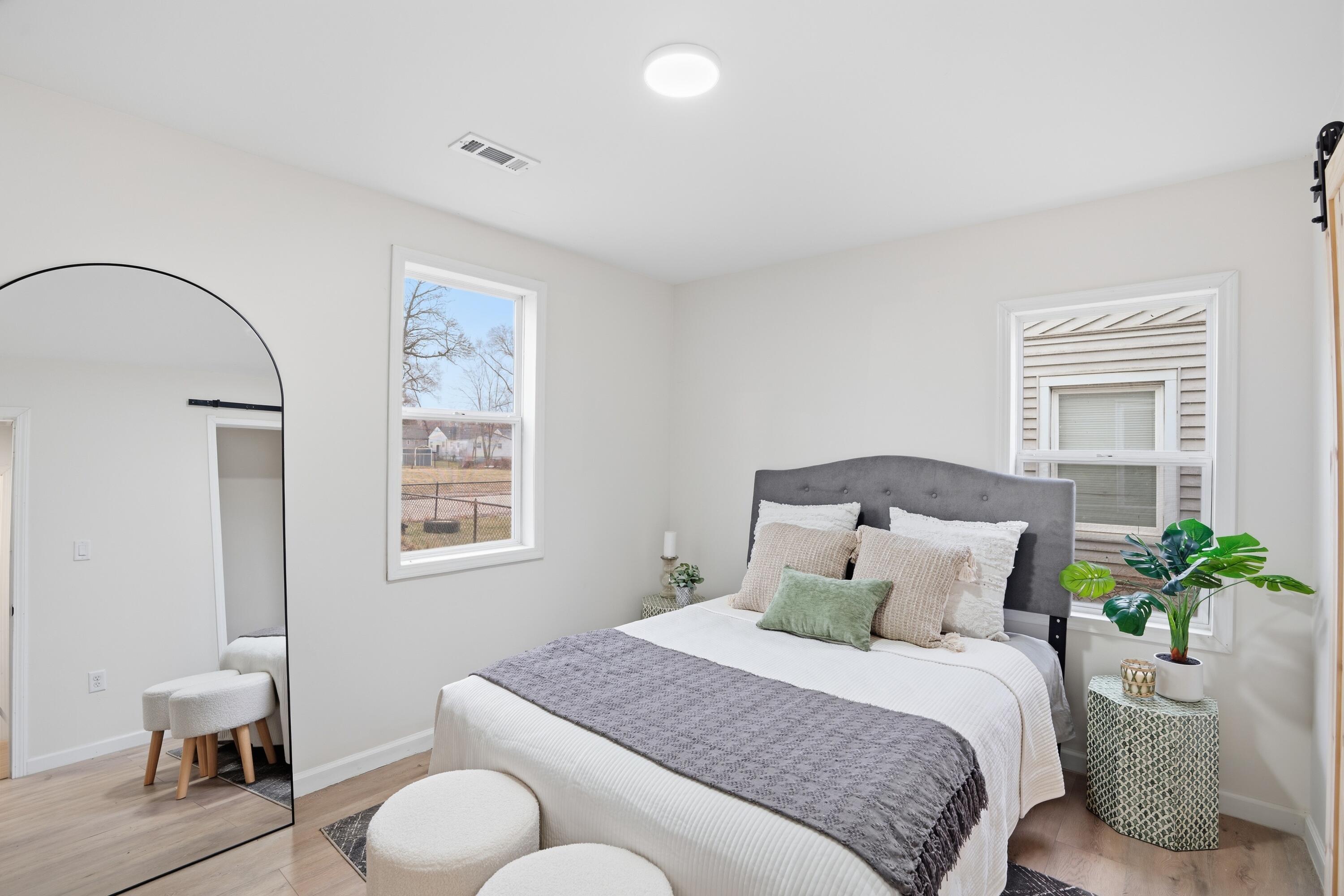 2314 Kentucky Street Gary, IN 46407 - Photo 12 of 16 a bedroom with a bed and chair