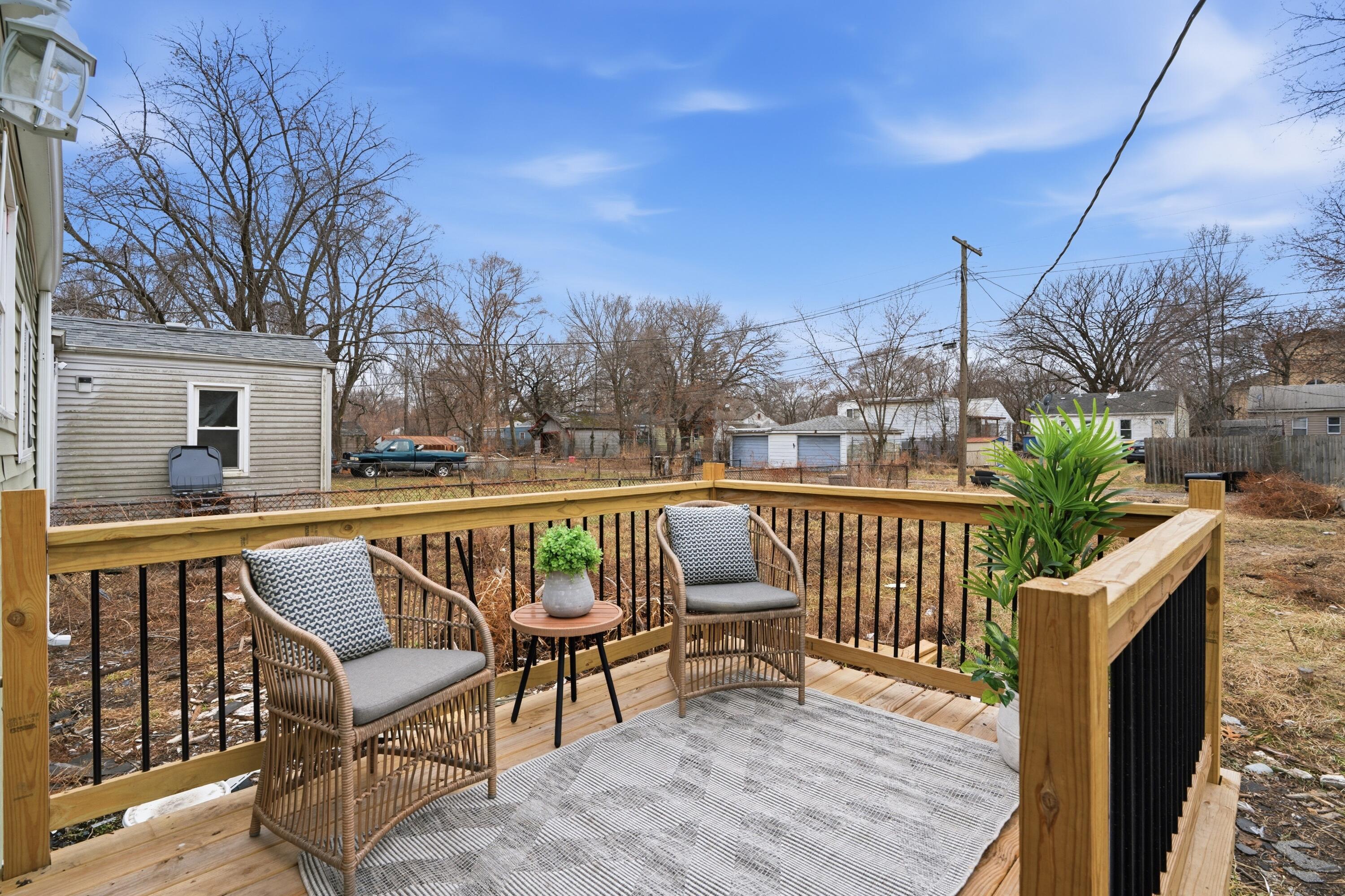 2314 Kentucky Street Gary, IN 46407 - Photo 16 of 16 a view of roof deck with two chairs and wooden fence