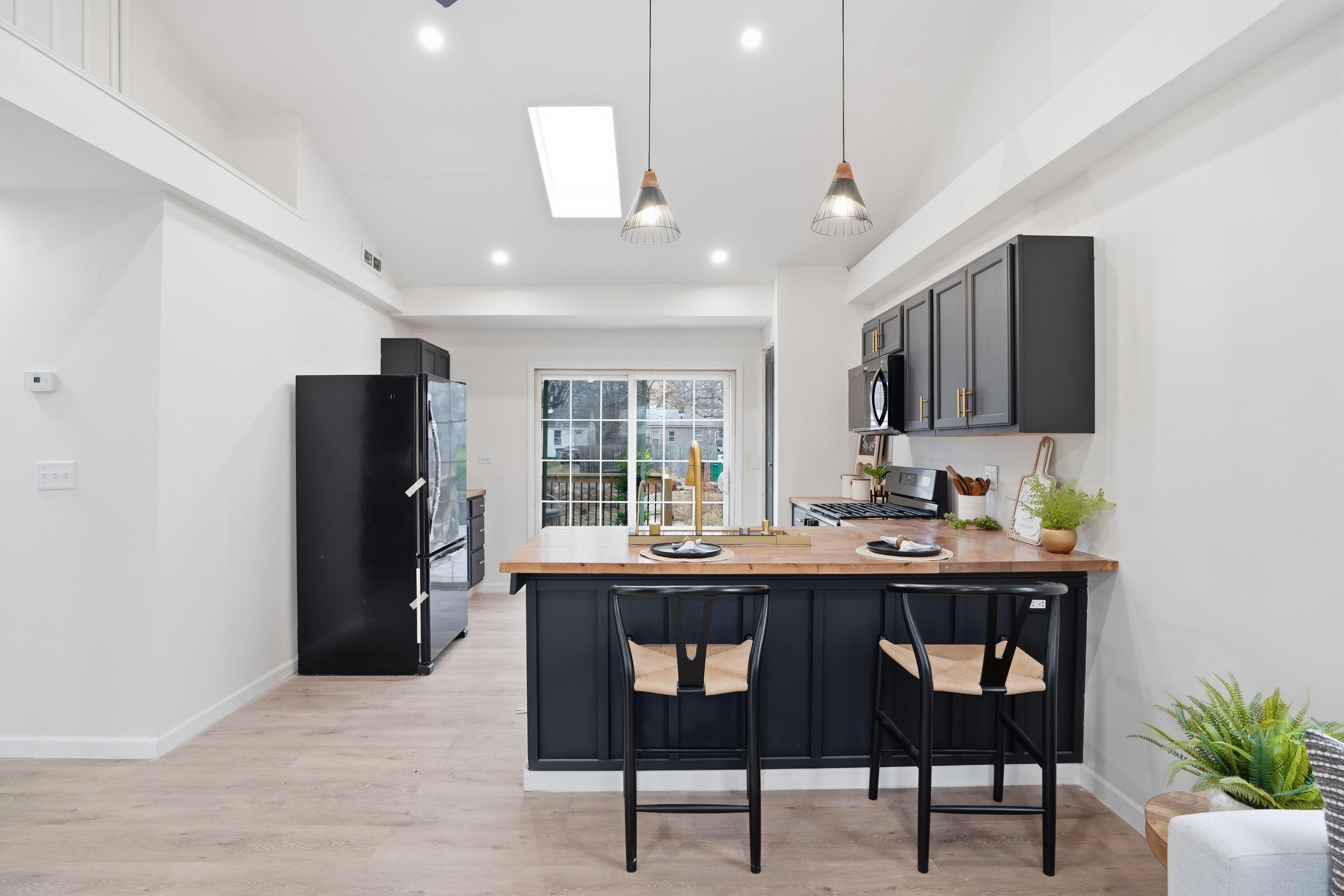 2314 Kentucky Street Gary, IN 46407 - Photo 5 of 16 a kitchen with stainless steel appliances granite countertop a stove refrigerator and dining table