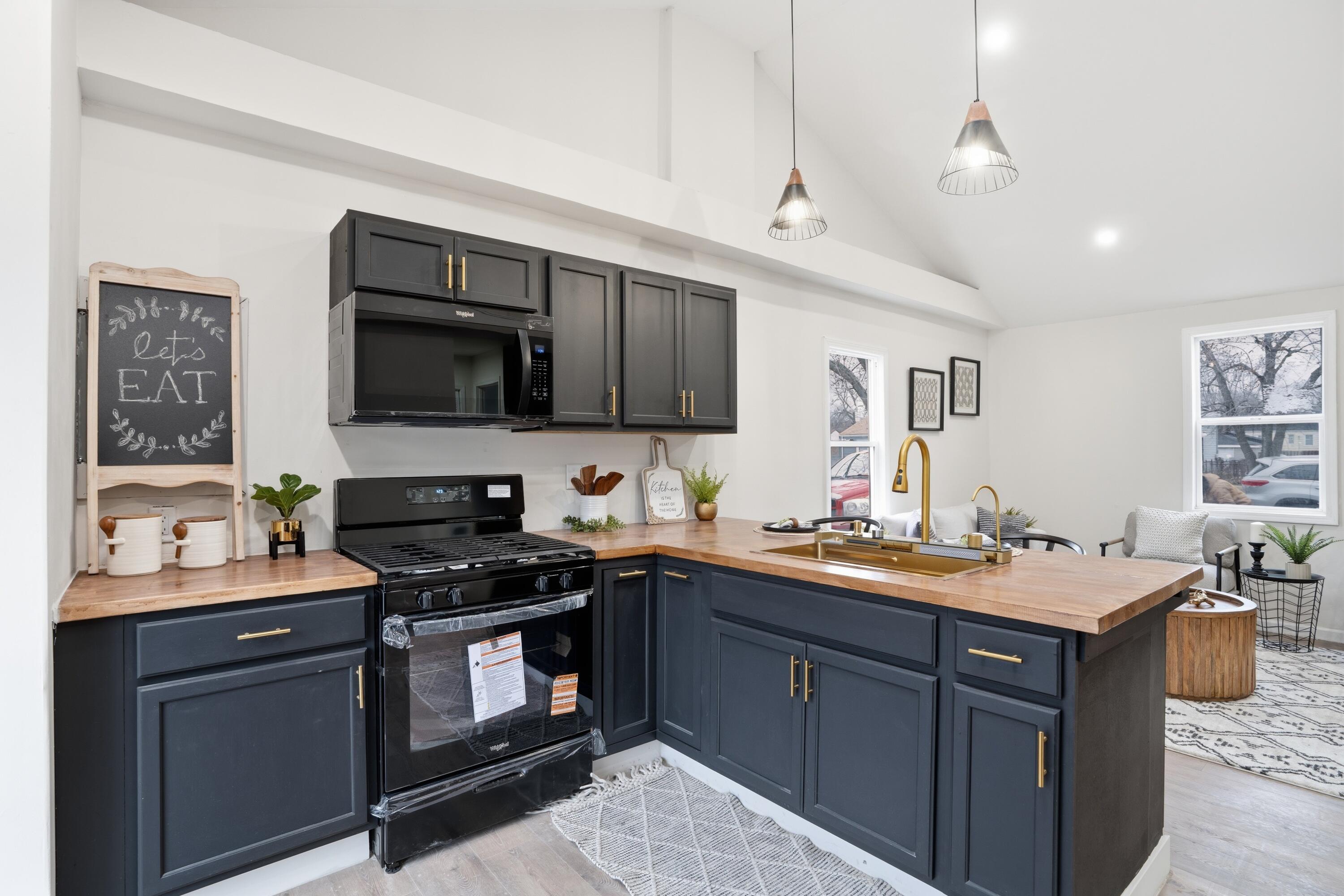2314 Kentucky Street Gary, IN 46407 - Photo 7 of 16 a kitchen with a sink stove top oven and cabinets