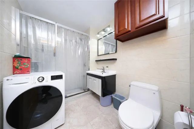 a bathroom with a toilet sink and mirror