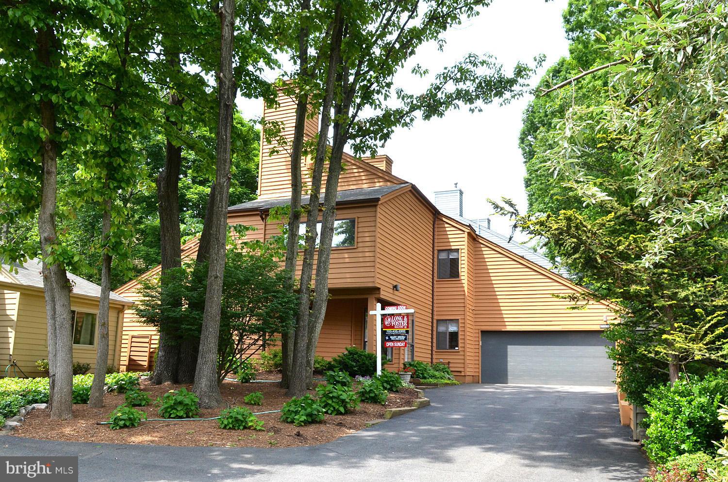 11030 Solaridge Drive Reston, VA 20191 - Photo 1 of 30 a front view of a house with garden
