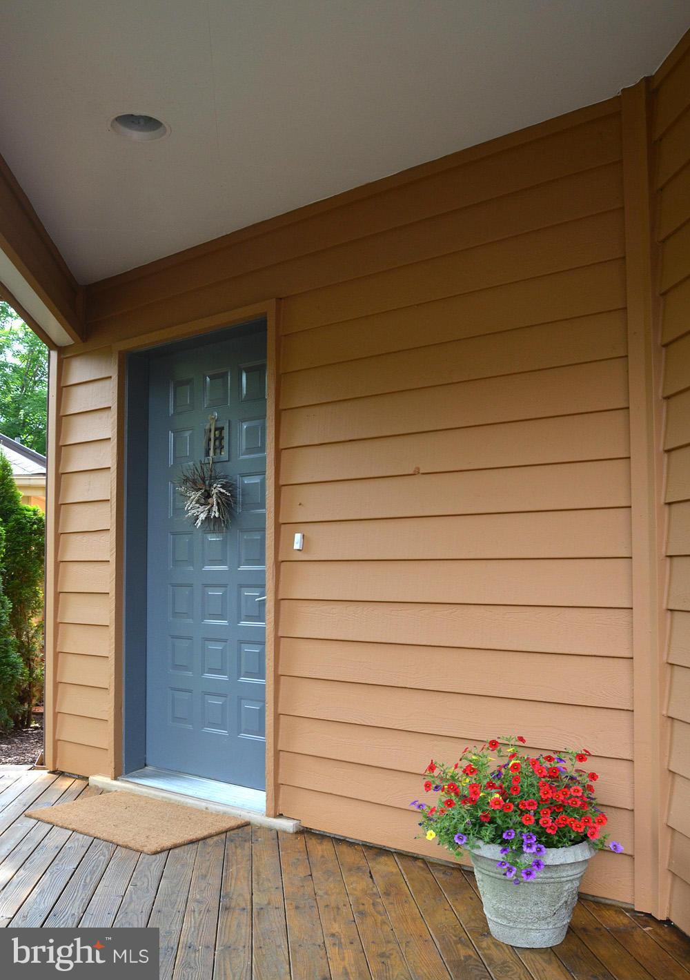 11030 Solaridge Drive Reston, VA 20191 - Photo 2 of 30 a view of a porch with dining table and potted plants